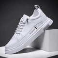 Men's white low-top skate shoes with a microfiber upper and elastic band, shown on a grey background.