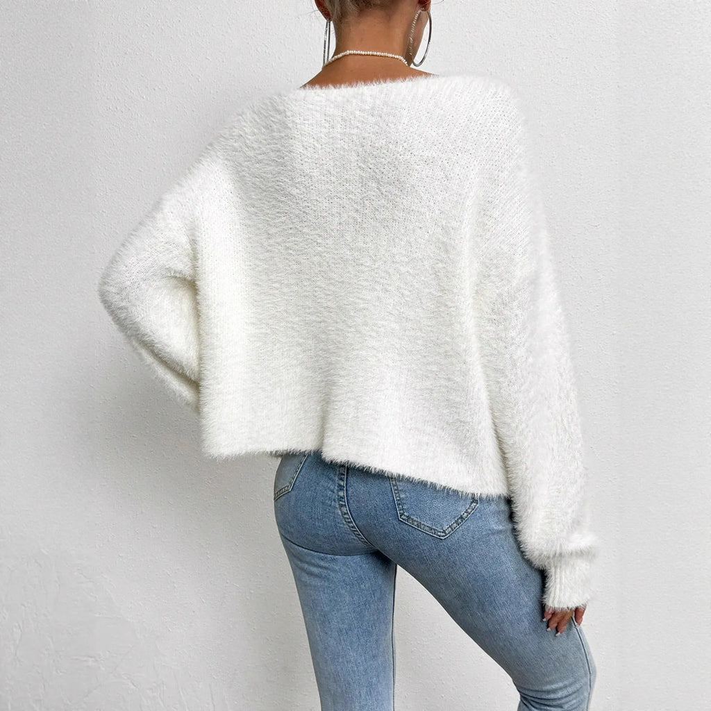 White women's V-neck cardigan sweater with bead knit detail on a hanger.