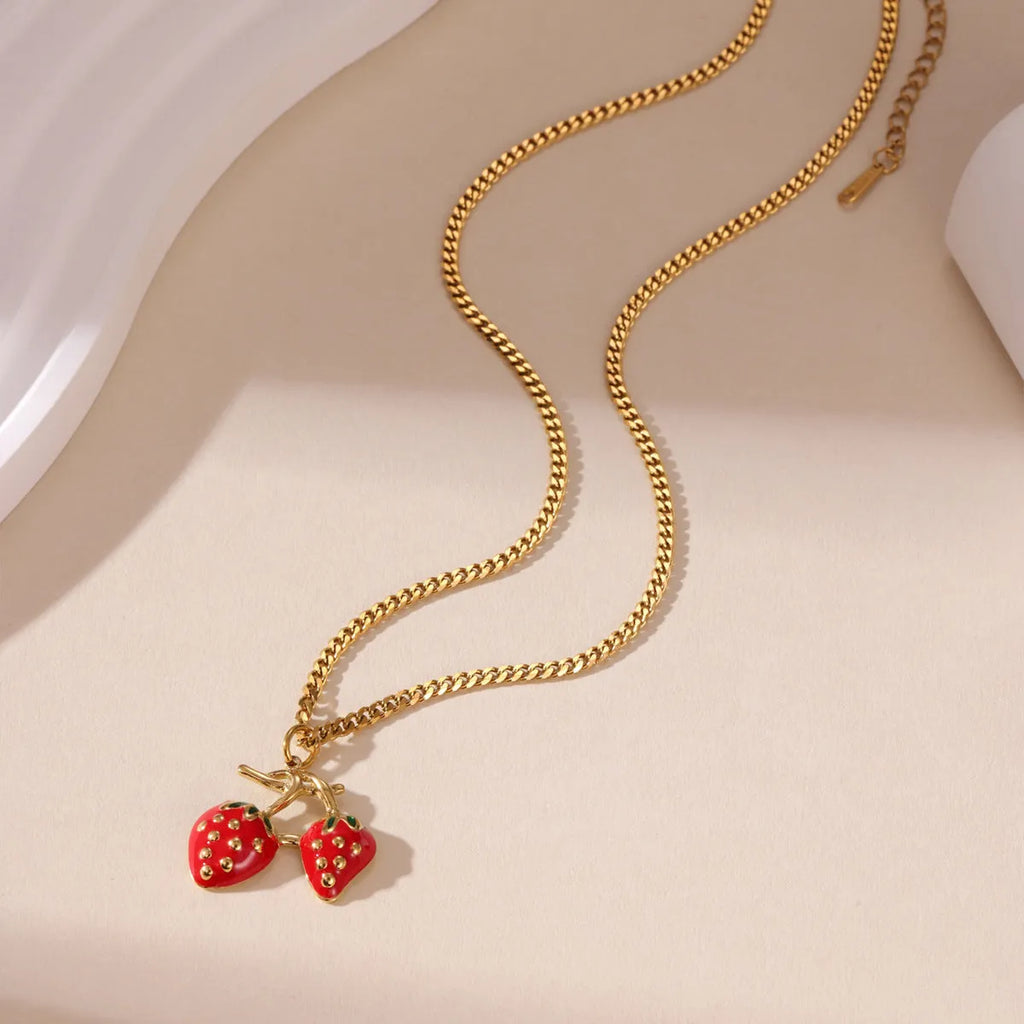 Stainless steel strawberry fruit pendant necklace on an alloy chain, shown in red and white gradient colour options.