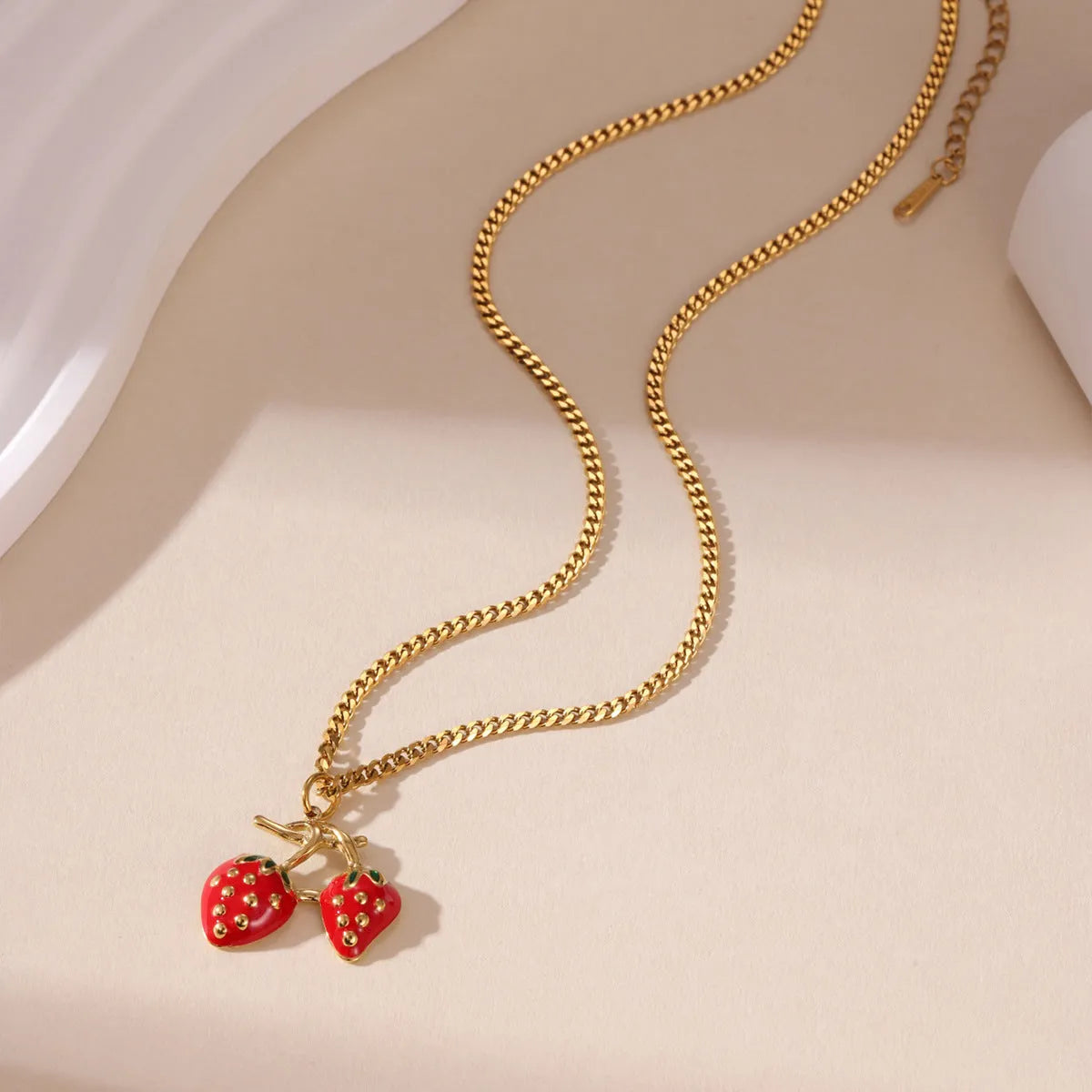 Stainless steel strawberry fruit pendant necklace on an alloy chain, shown in red and white gradient colour options.