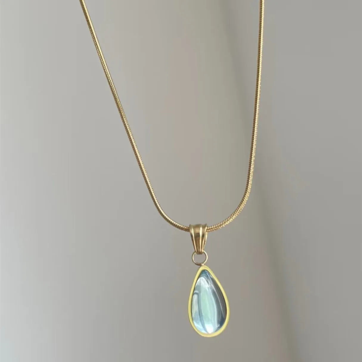 Retro blue and green water drop necklace with gemstone inlay on a titanium steel snake bone chain.