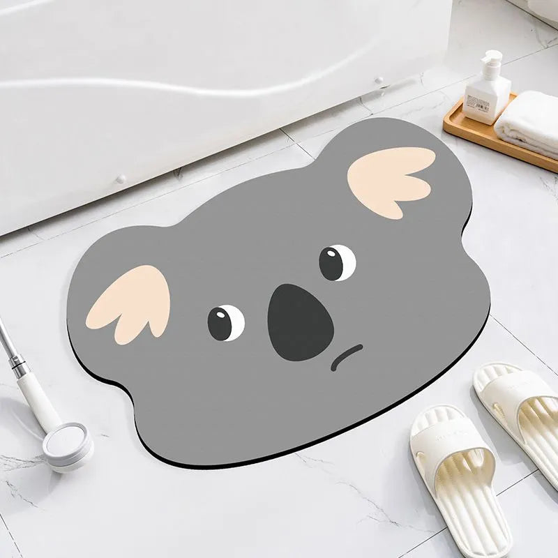 Cartoon animal diatomite bathroom mat in alien shape on tiled floor.