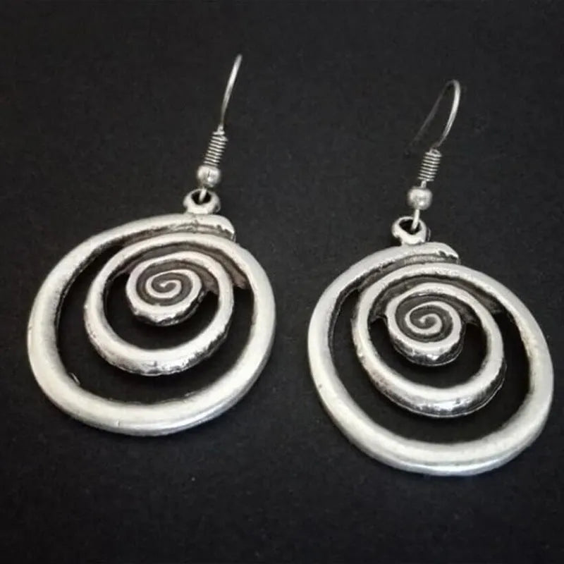 Silver geometric spiral earrings with distressed finish, measuring 2.6cm wide by 5cm long