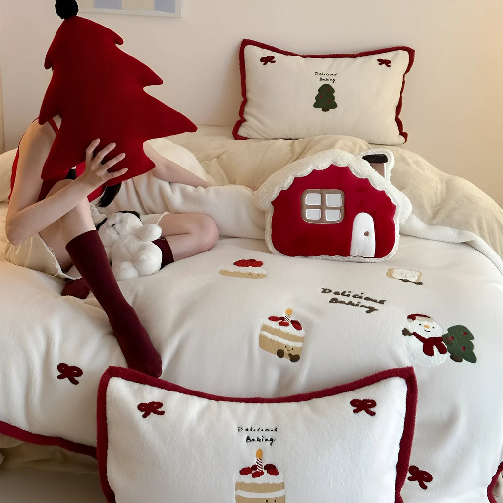 Winter Christmas cartoon bedding four-piece set with snowman and heart pattern on duvet cover and pillowcases.