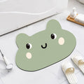 Cartoon animal diatomite bathroom mat in alien shape on tiled floor.