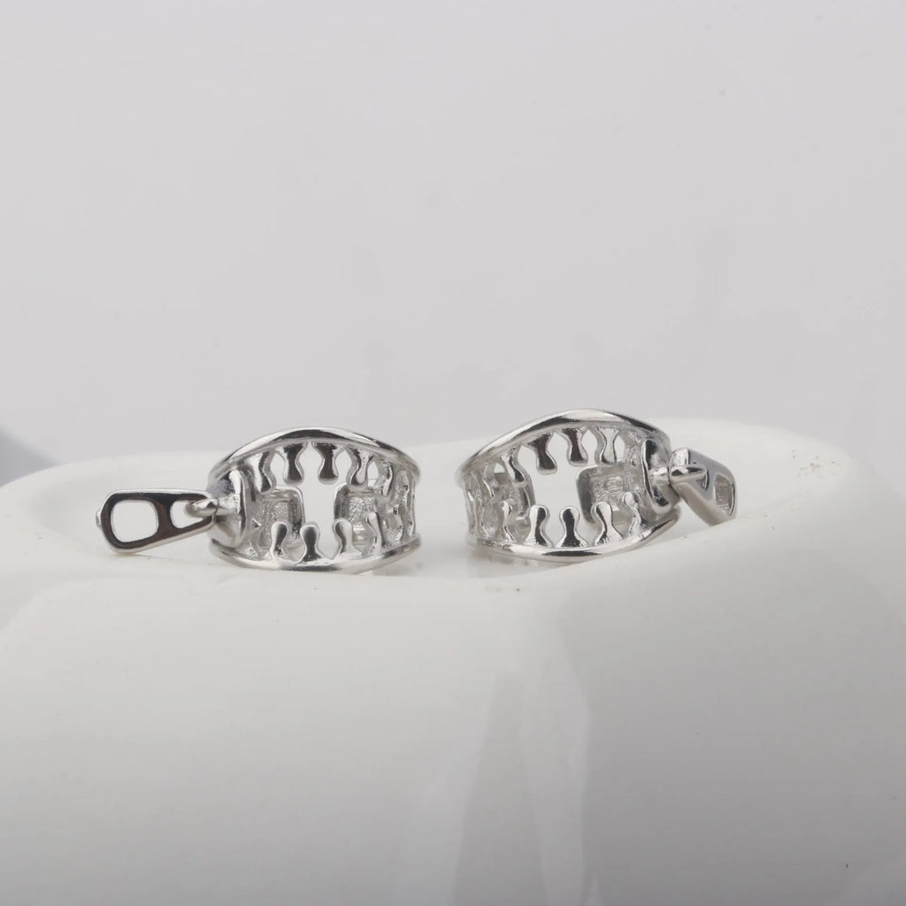 A pair of geometric bone clip earrings made from copper with linear details and an ear clip back.