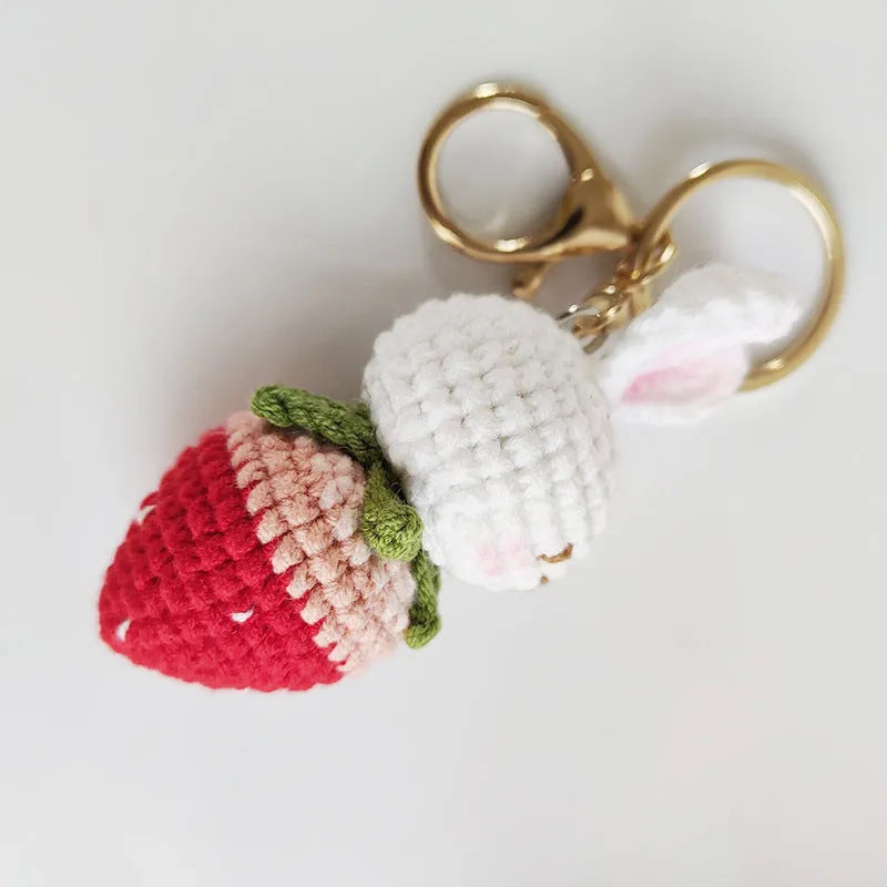 White hand-woven wire pendant with cartoon rabbit strawberry design and attached metal key