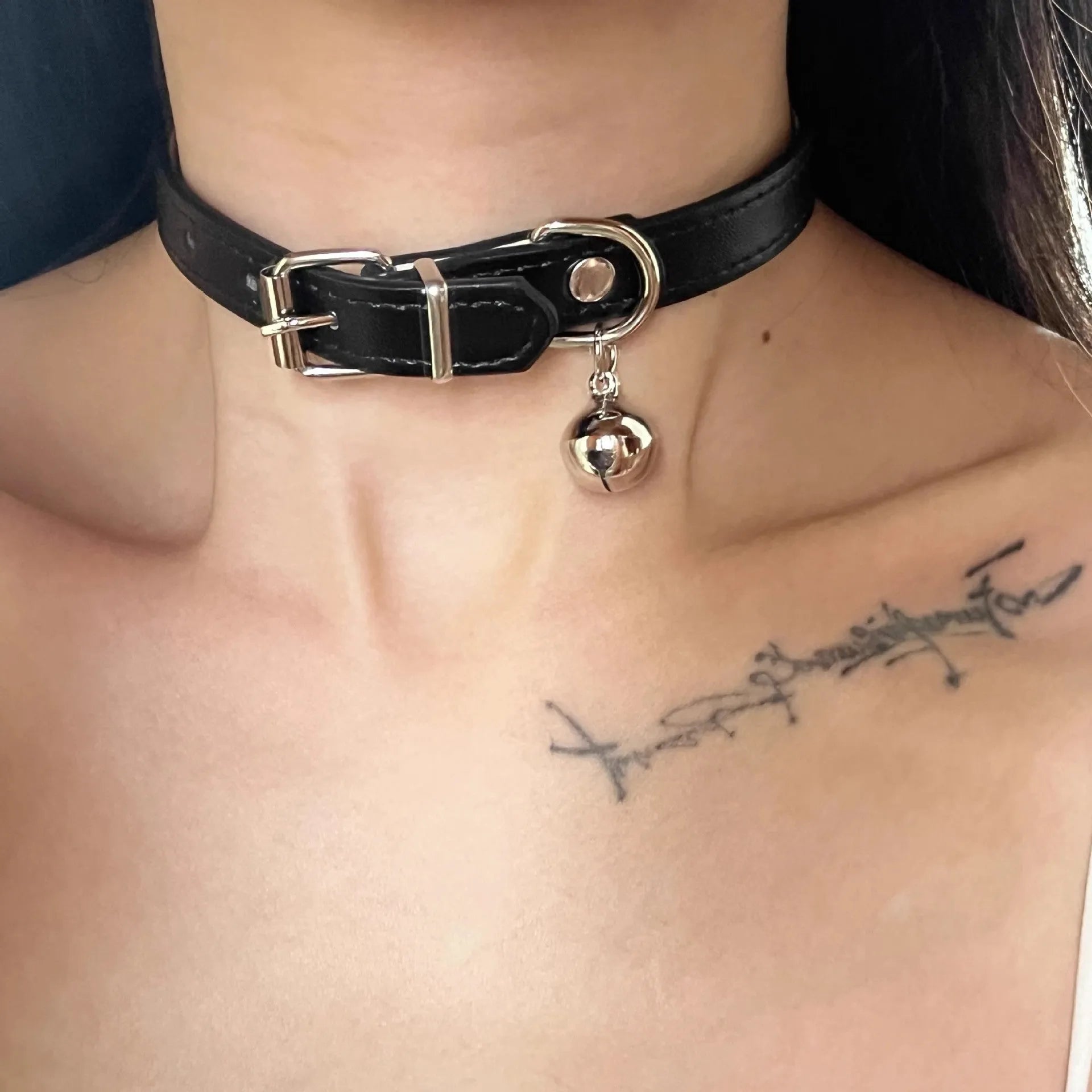 Black leather adjustable dog collar with a small bell charm, shown in cat's paw, bone, and plain design variants.