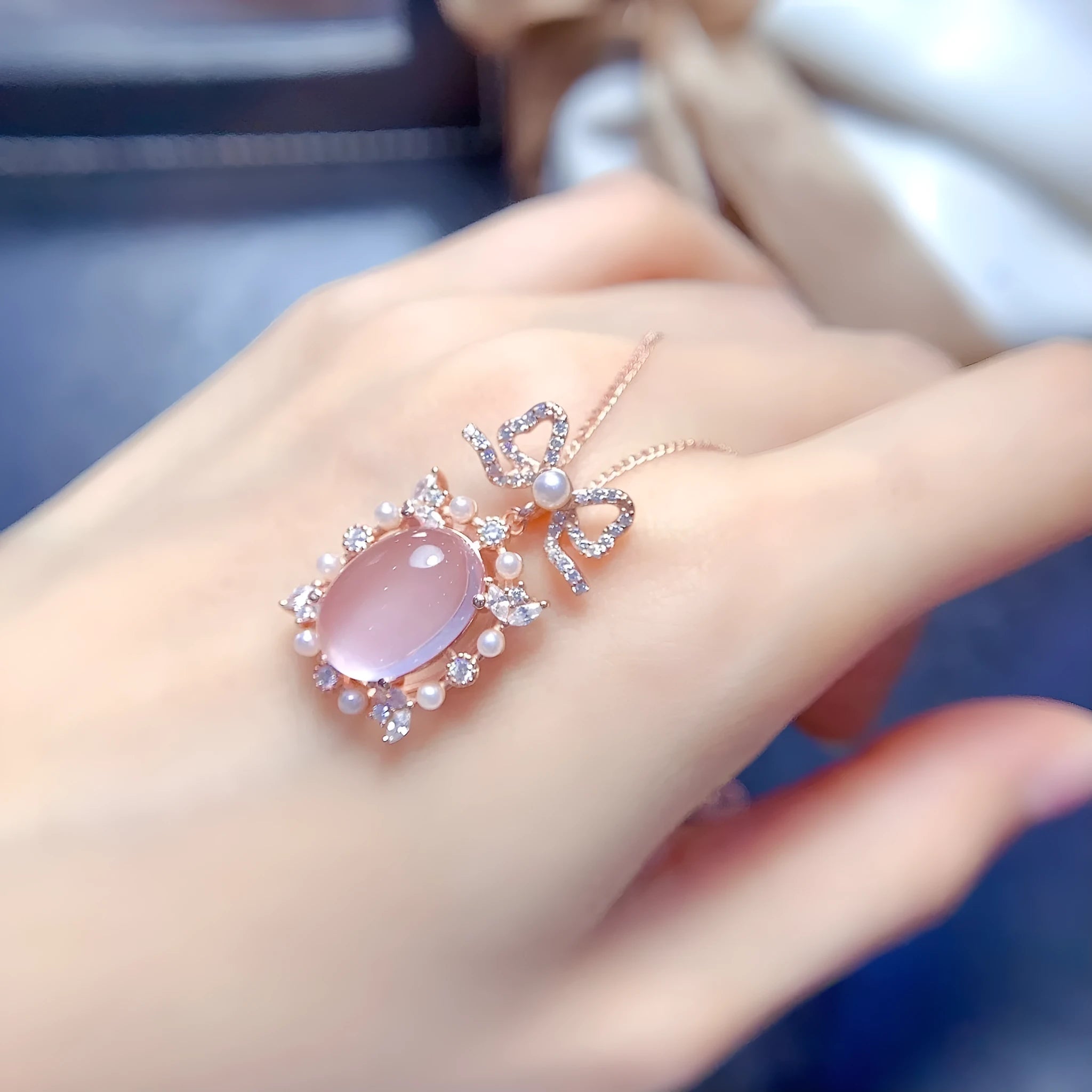 Geometric rose quartz crystal pendant on a silver chain with rose gold plating