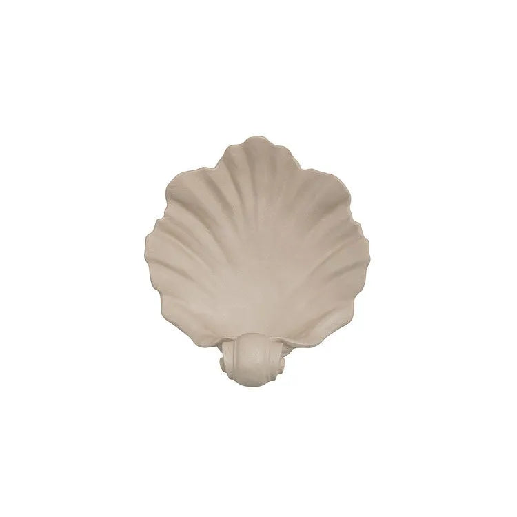 White resin simulation shell fruit plate ornament on a table.