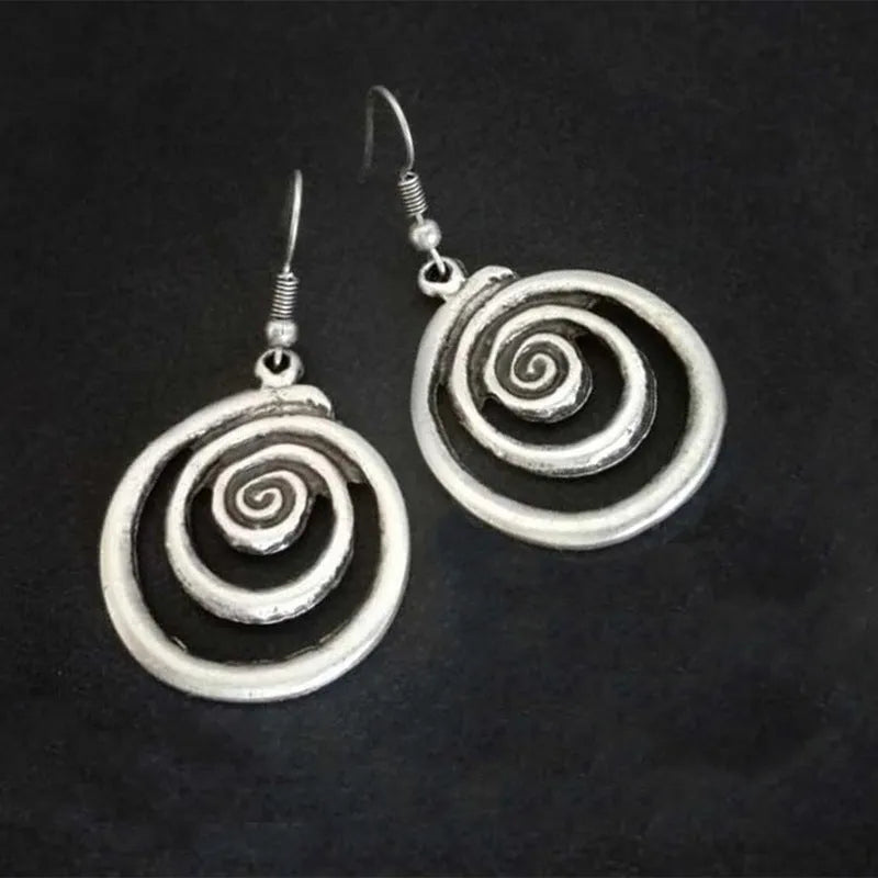 Silver geometric spiral earrings with distressed finish, measuring 2.6cm wide by 5cm long