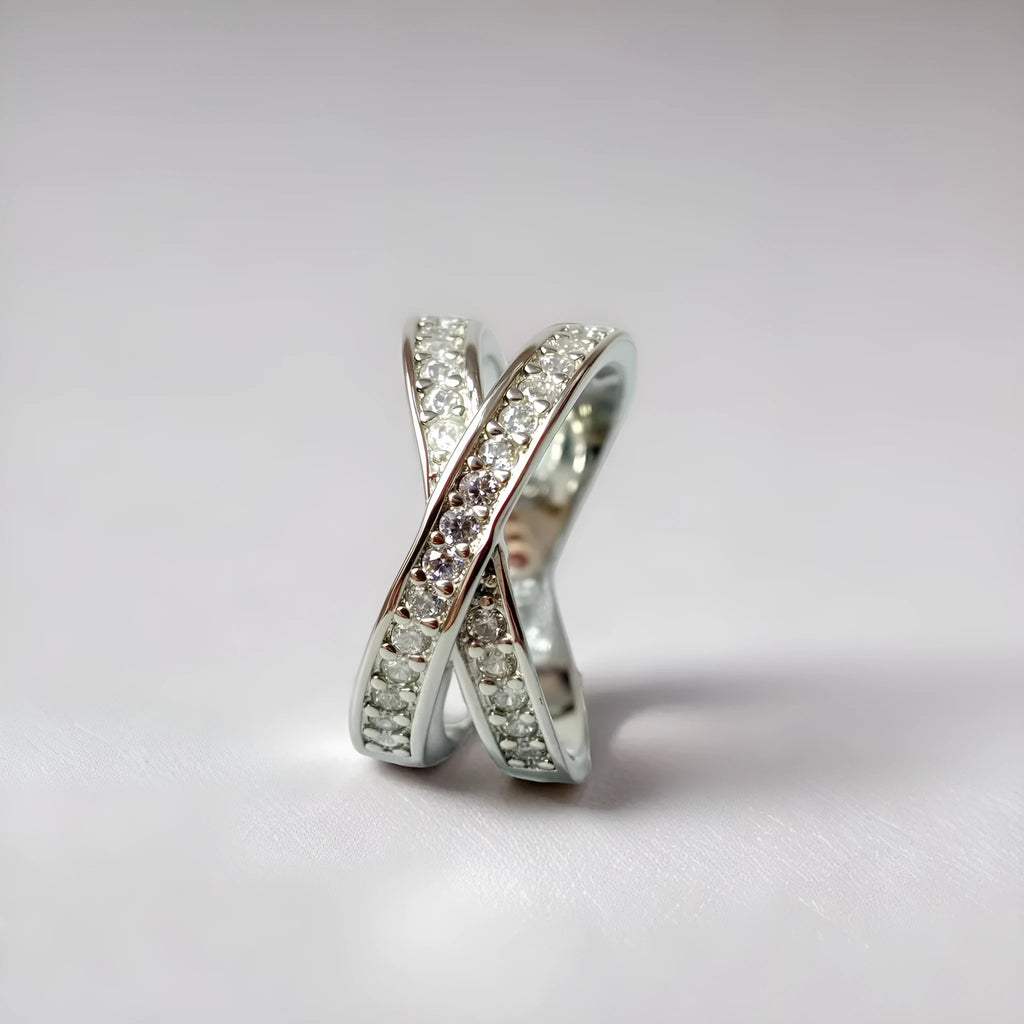 Geometric heart-shaped cross ring with micro-inlaid zircon on a copper base with silver or rose gold electroplated finish.