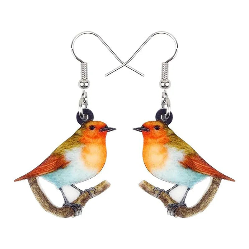 Blue Titmouse pendant earrings with geometric and snake designs on acrylic