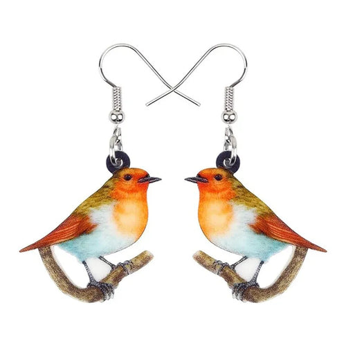 Blue Titmouse pendant earrings with geometric and snake designs on acrylic