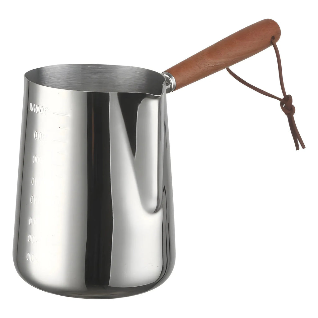 Stainless steel barista milk cup with measurement scale markings and a wooden handle.