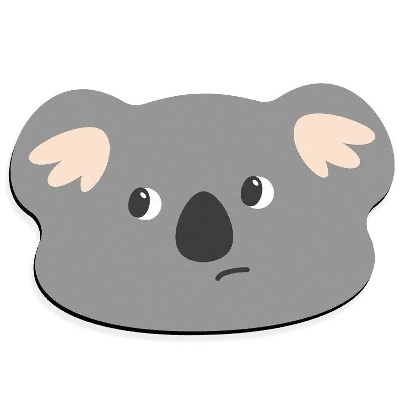 Cartoon animal diatomite bathroom mat in alien shape on tiled floor.