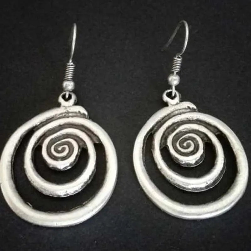 Silver geometric spiral earrings with distressed finish, measuring 2.6cm wide by 5cm long