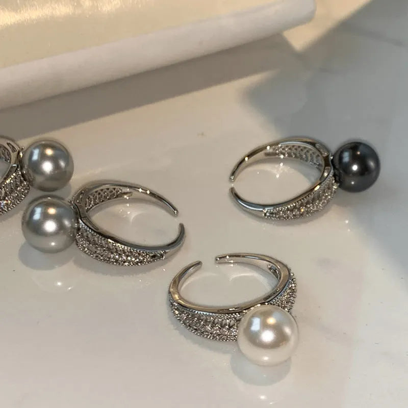 Geometric open copper ring for women with a black pearl on an adjustable band.