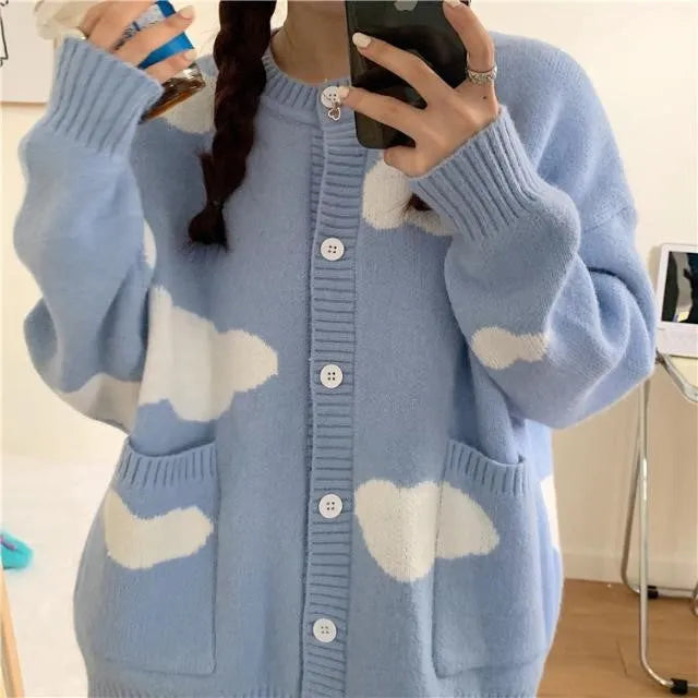 Blue women's cardigan with white cloud pattern, loose fit and long sleeves.