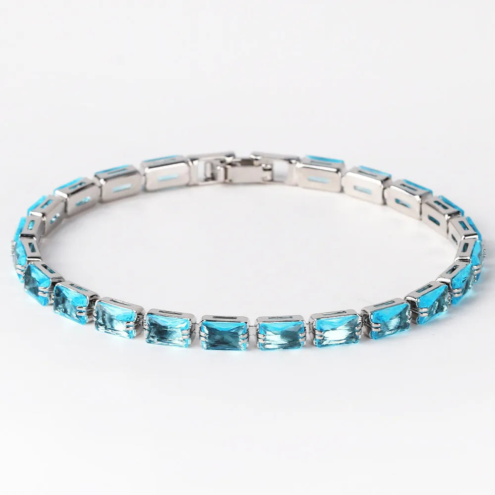 Adjustable electroplated zircon bracelet in gold finish with coloured zircon accents