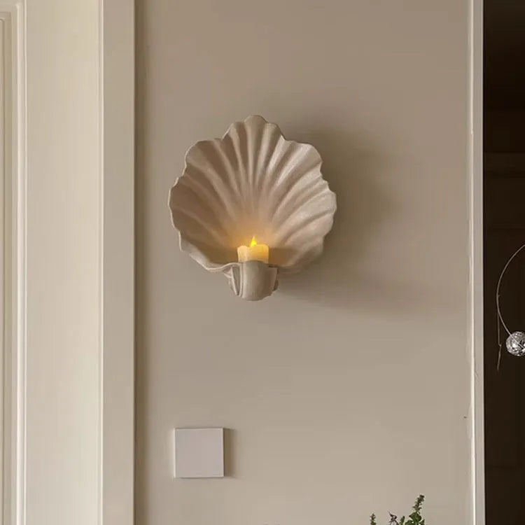 White resin simulation shell fruit plate ornament on a table.