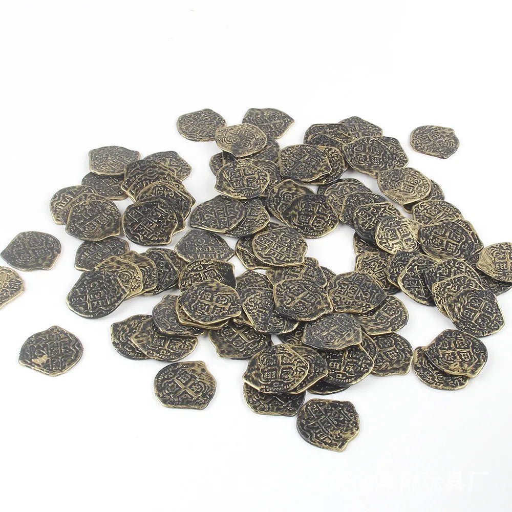 Three piles of plastic Roman coins replica in bronze, gold and silver finishes for pirate treasure decoration