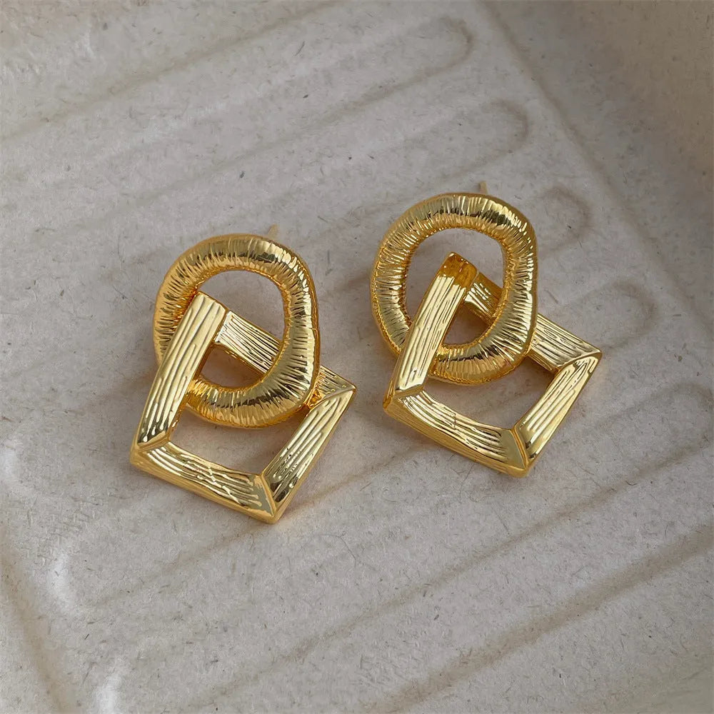 Geometric circle pendant earrings with gold electroplated finish showing 3.4 cm height measurement