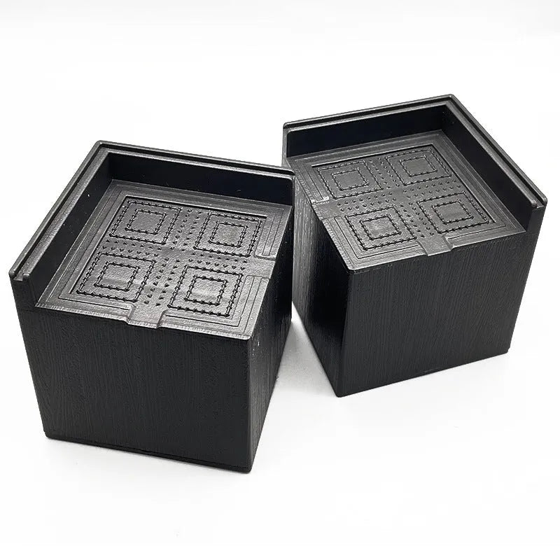 Four black plastic furniture foot mats for increasing bed and sofa height