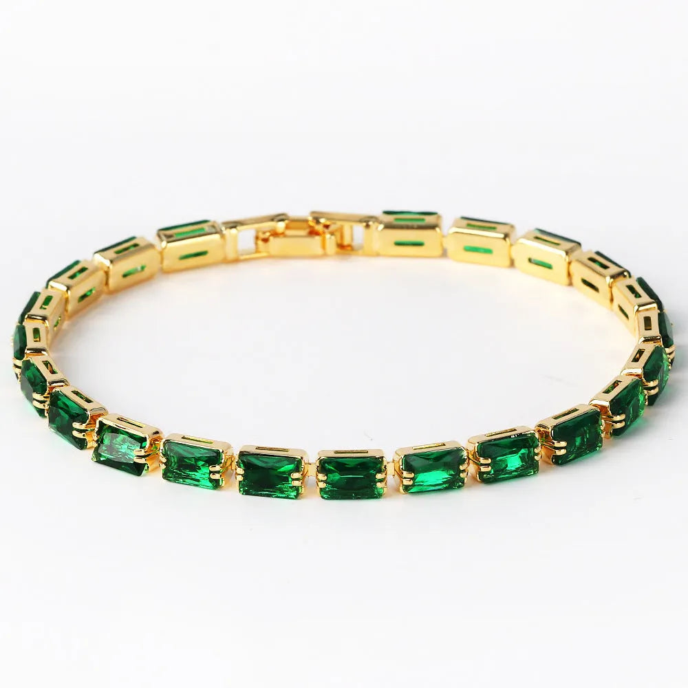 Adjustable electroplated zircon bracelet in gold finish with coloured zircon accents