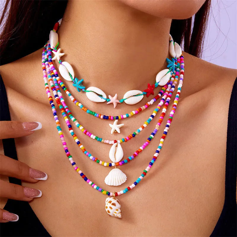 Five multi-layer beaded necklaces with starfish and shell charms in blue and colours