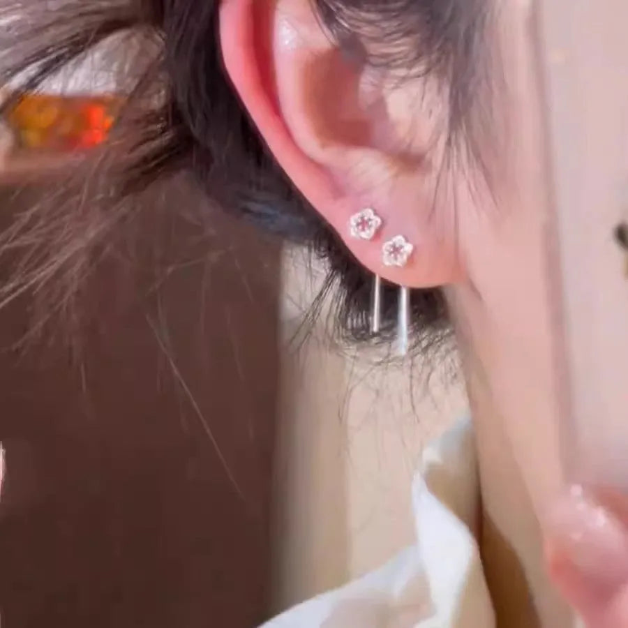 Pair of silver hollow flower stud earrings with detailed petals, alloy material with natural style