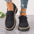 Black plus size women's loafers with tassel decoration, bowknot detail, and chunky rubber sole