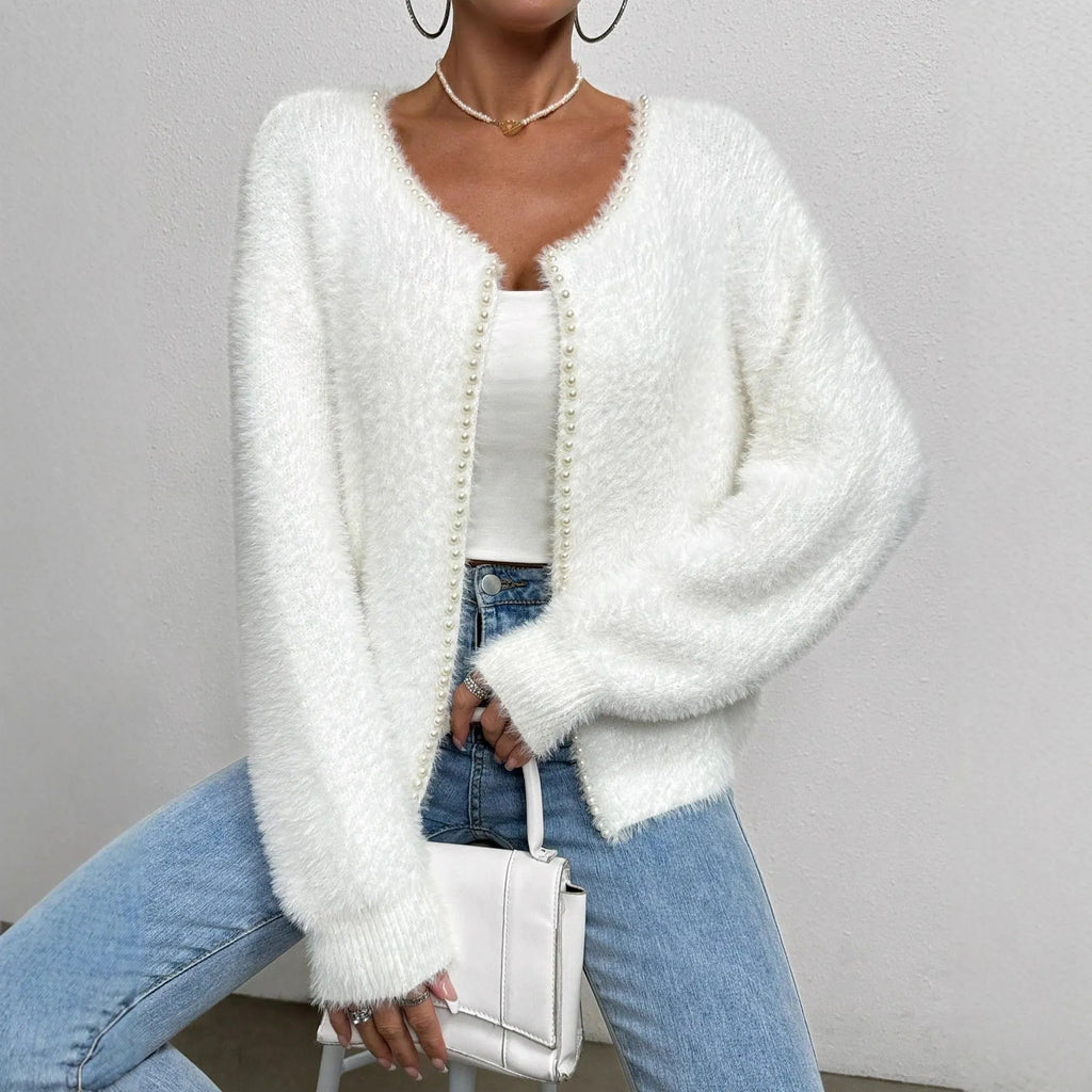 White women's V-neck cardigan sweater with bead knit detail on a hanger.