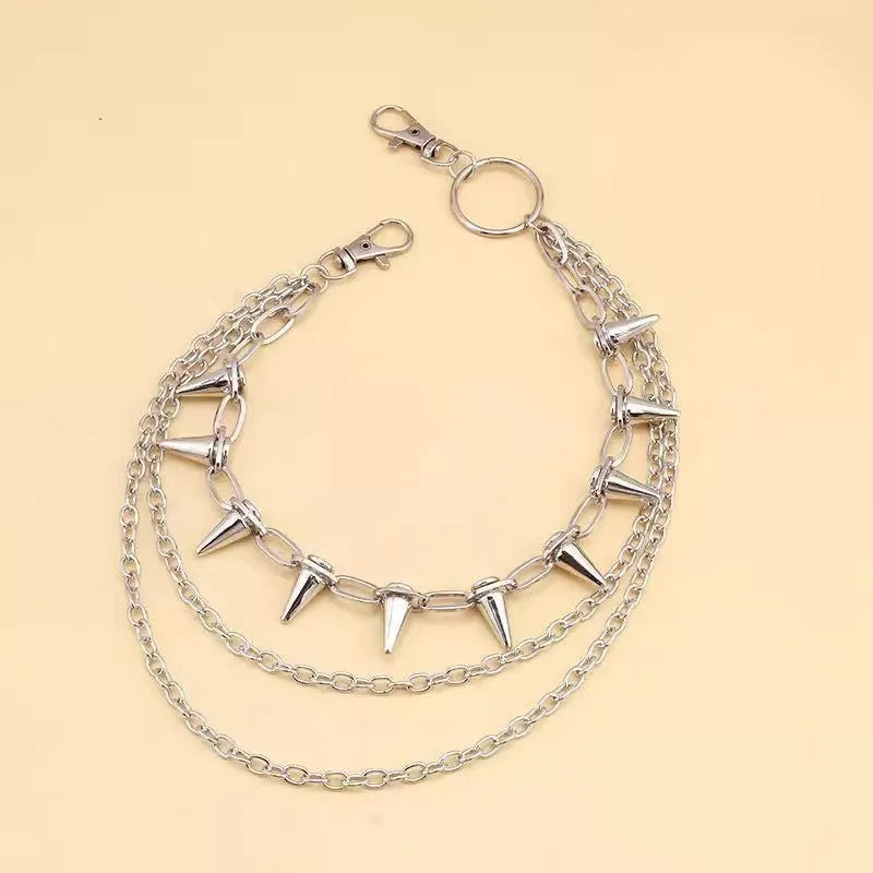Silver metal double-layer rivet chain trousers accessory with zip fastening on a dark background.