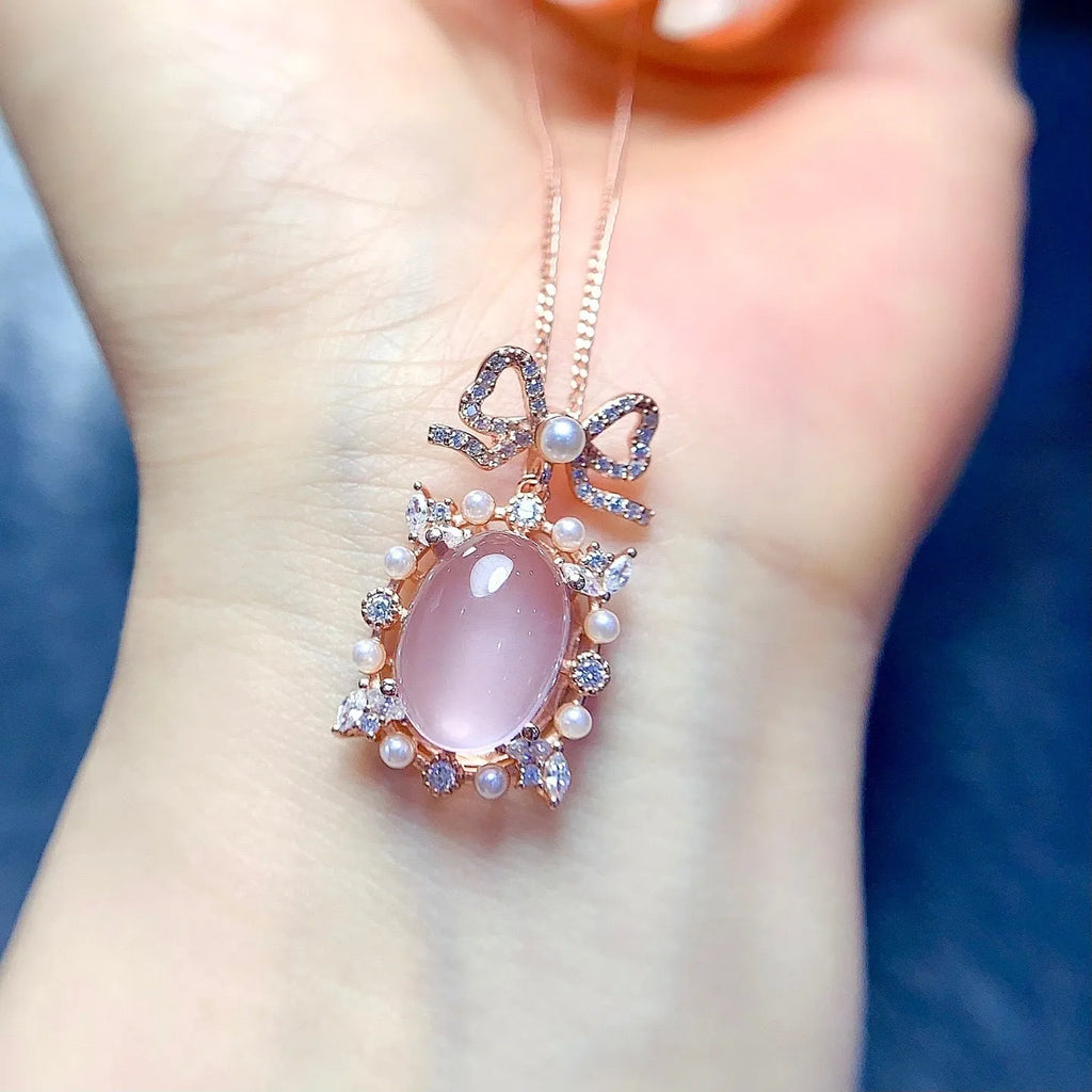 Geometric rose quartz crystal pendant on a silver chain with rose gold plating