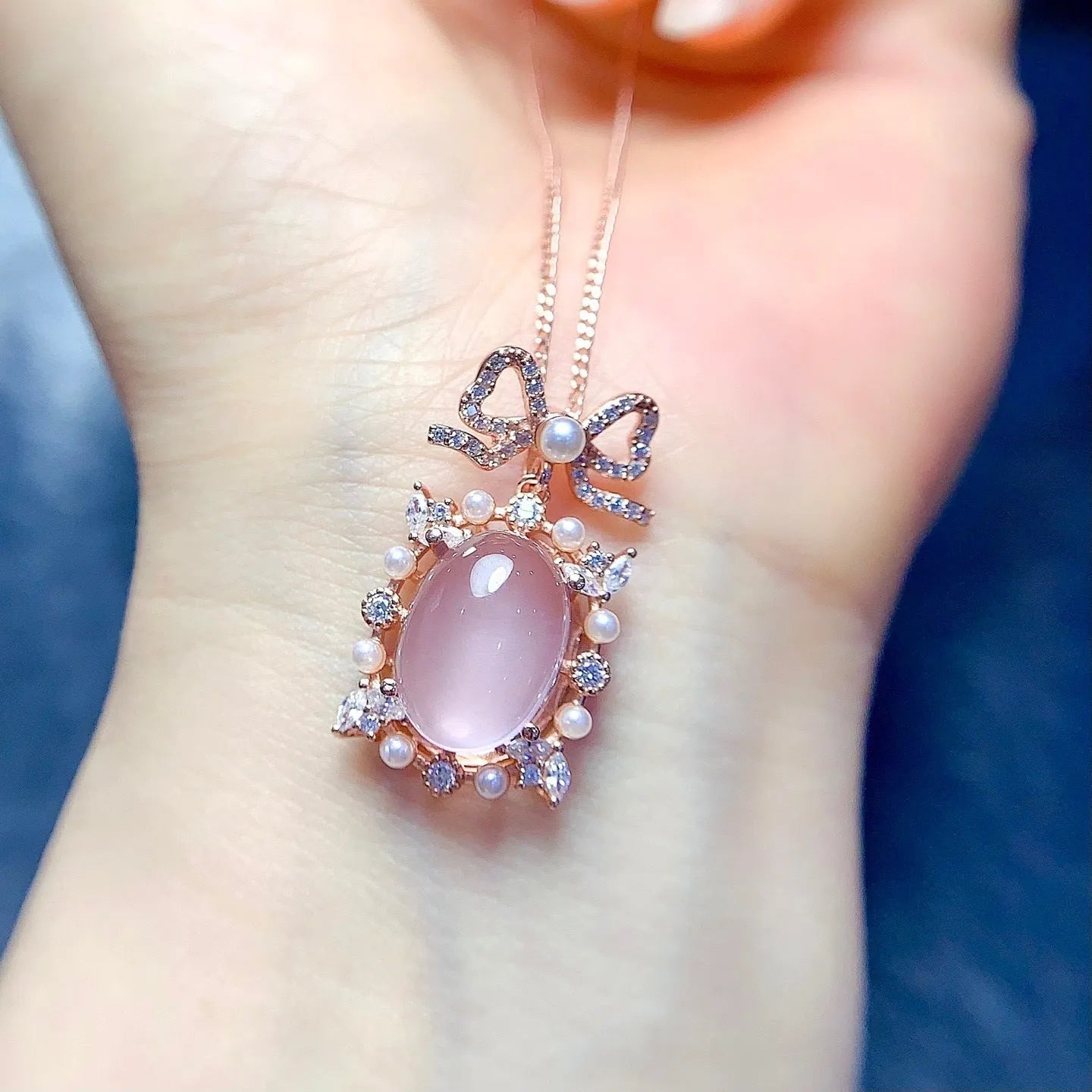 Geometric rose quartz crystal pendant on a silver chain with rose gold plating