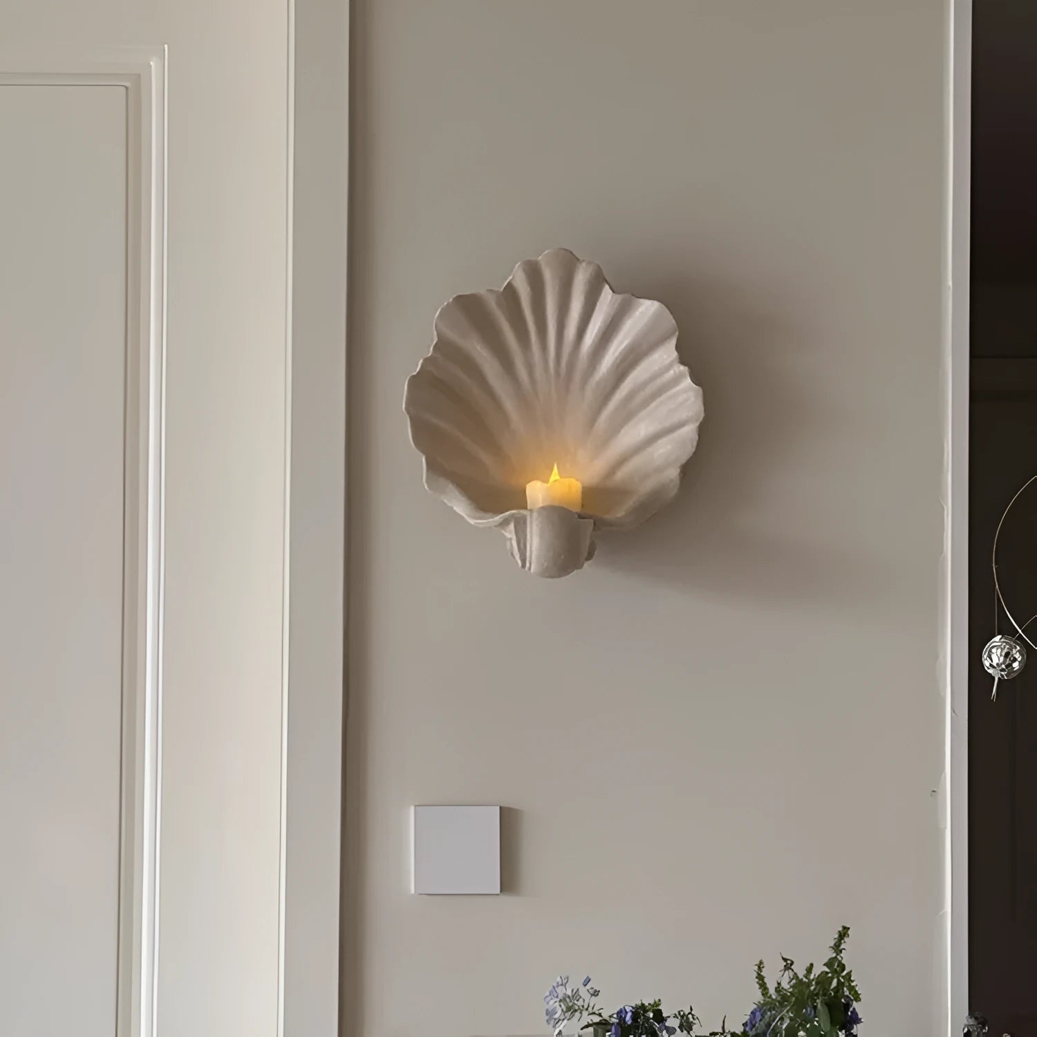 White resin simulation shell fruit plate ornament on a table.