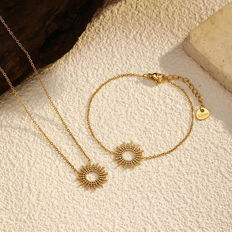 Gold geometric necklace and bracelet jewellery set with chain elements and Y-shaped pendant