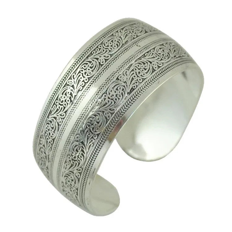 Open carved Miao silver alloy bracelet with elephant and turtle motifs on a Roman-shaped band.