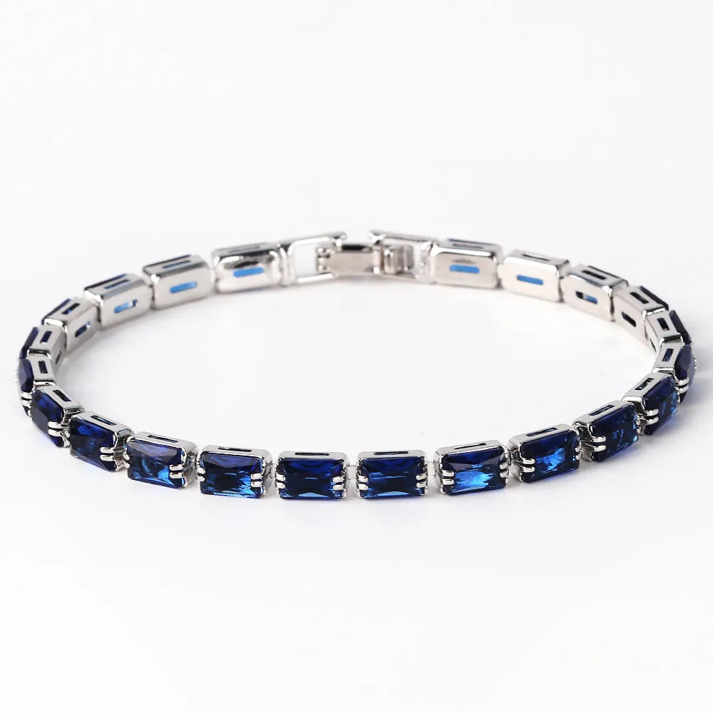 Adjustable electroplated zircon bracelet in gold finish with coloured zircon accents