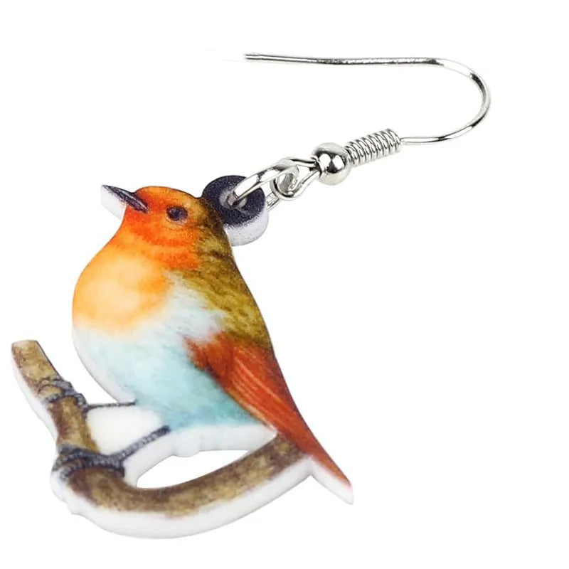 Blue Titmouse pendant earrings with geometric and snake designs on acrylic