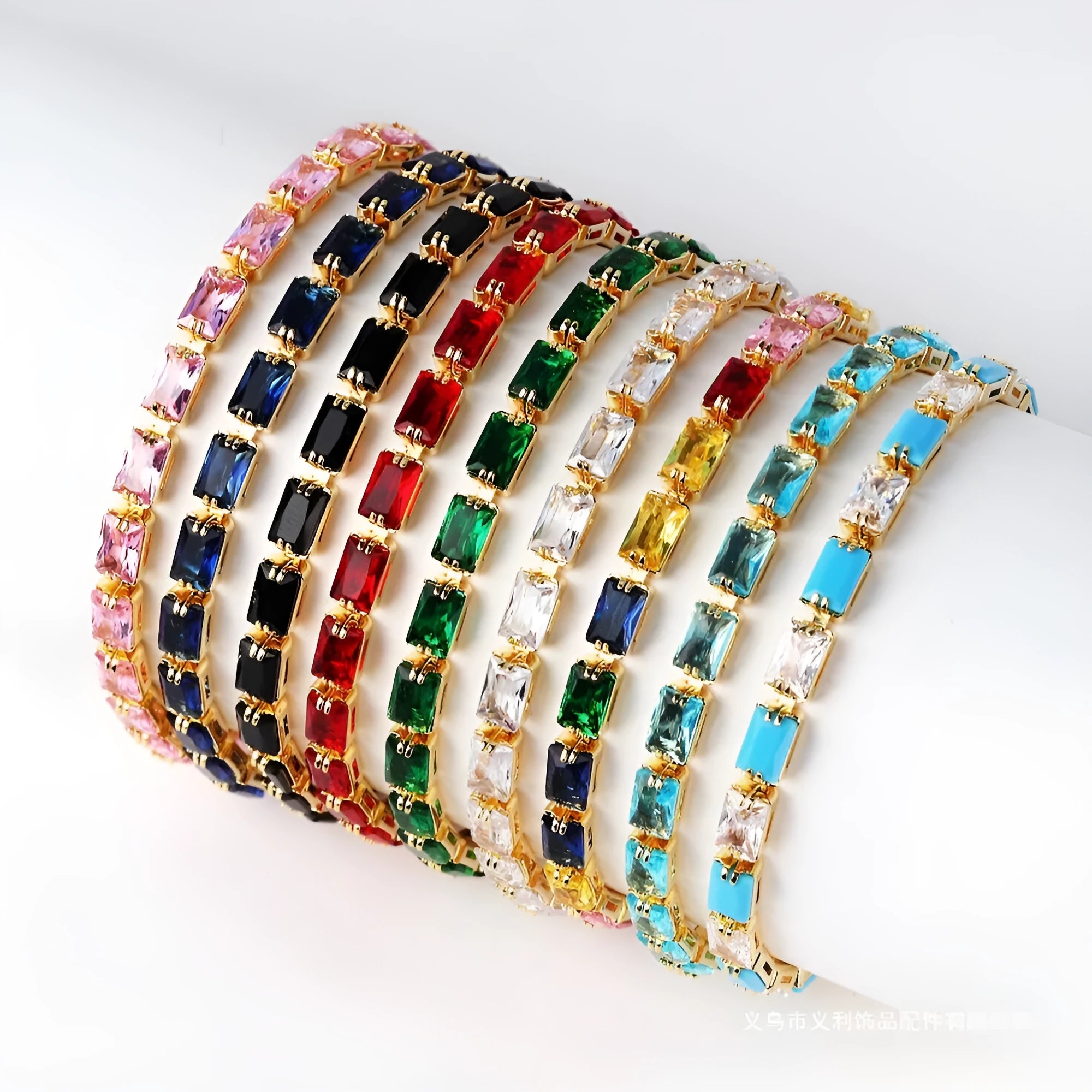 Adjustable electroplated zircon bracelet in gold finish with coloured zircon accents