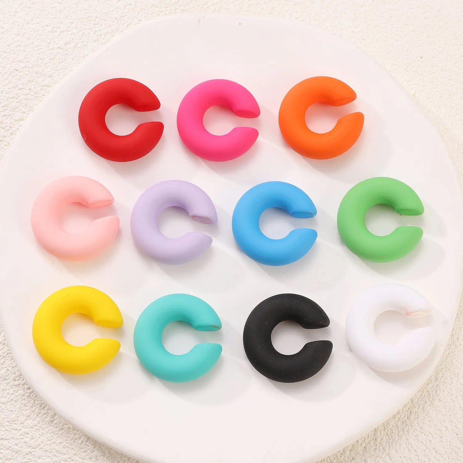 Geometric C-shape clip-on earrings with matte coarse finish in candy colours for women without pierced ears