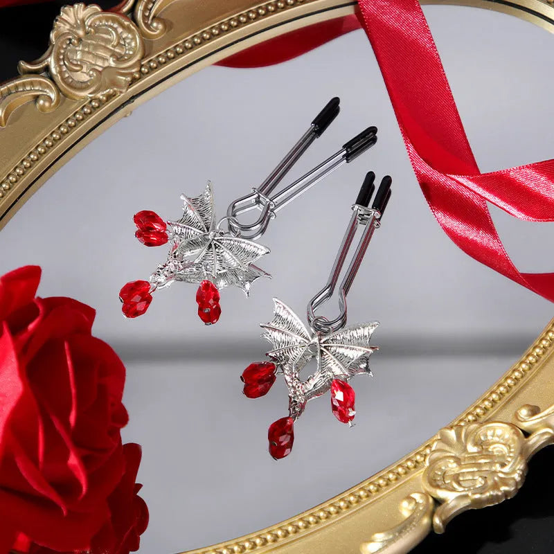 Silver alloy bat nipple clamp with ruby design showing adjustable pressure mechanism