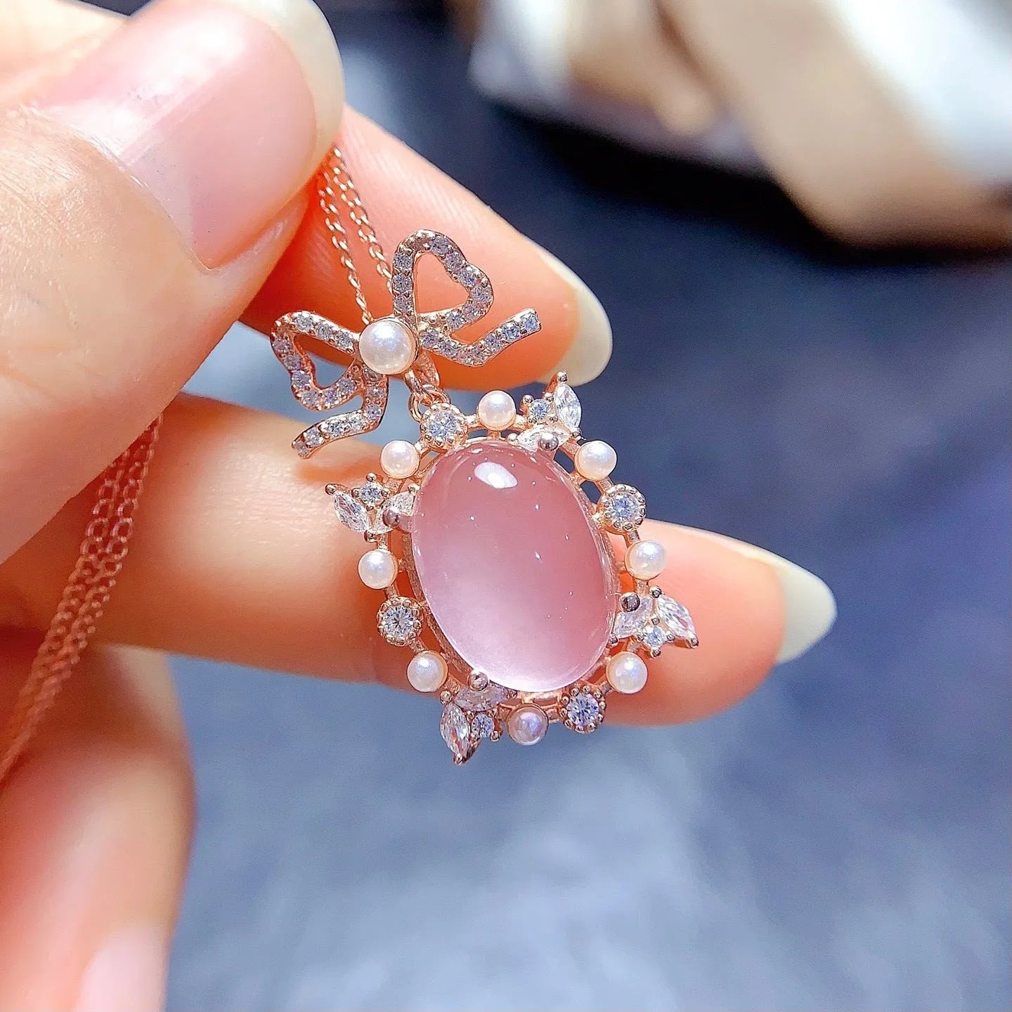 Geometric rose quartz crystal pendant on a silver chain with rose gold plating