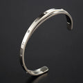 Open-ended women's bracelet with inlaid zircon stones on wrist