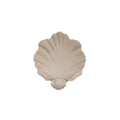 White resin simulation shell fruit plate ornament on a table.