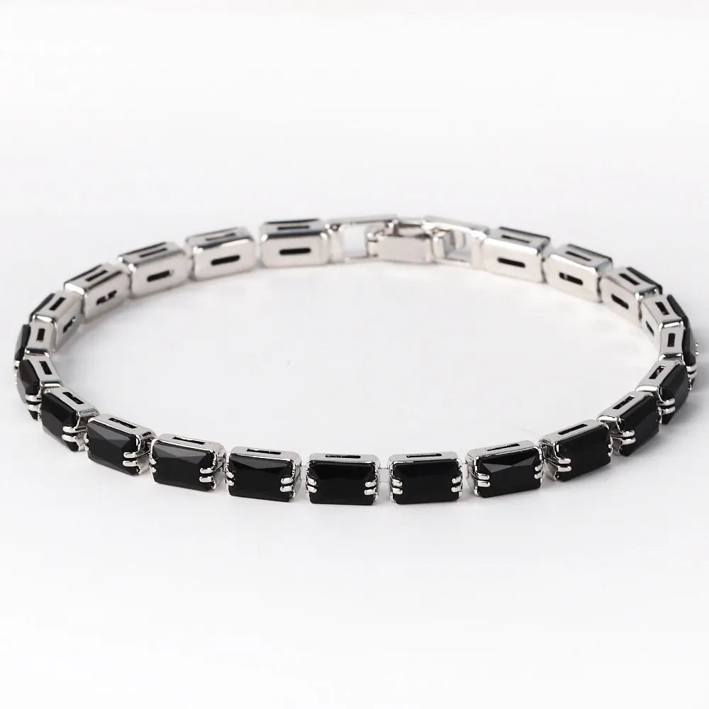 Adjustable electroplated zircon bracelet in gold finish with coloured zircon accents