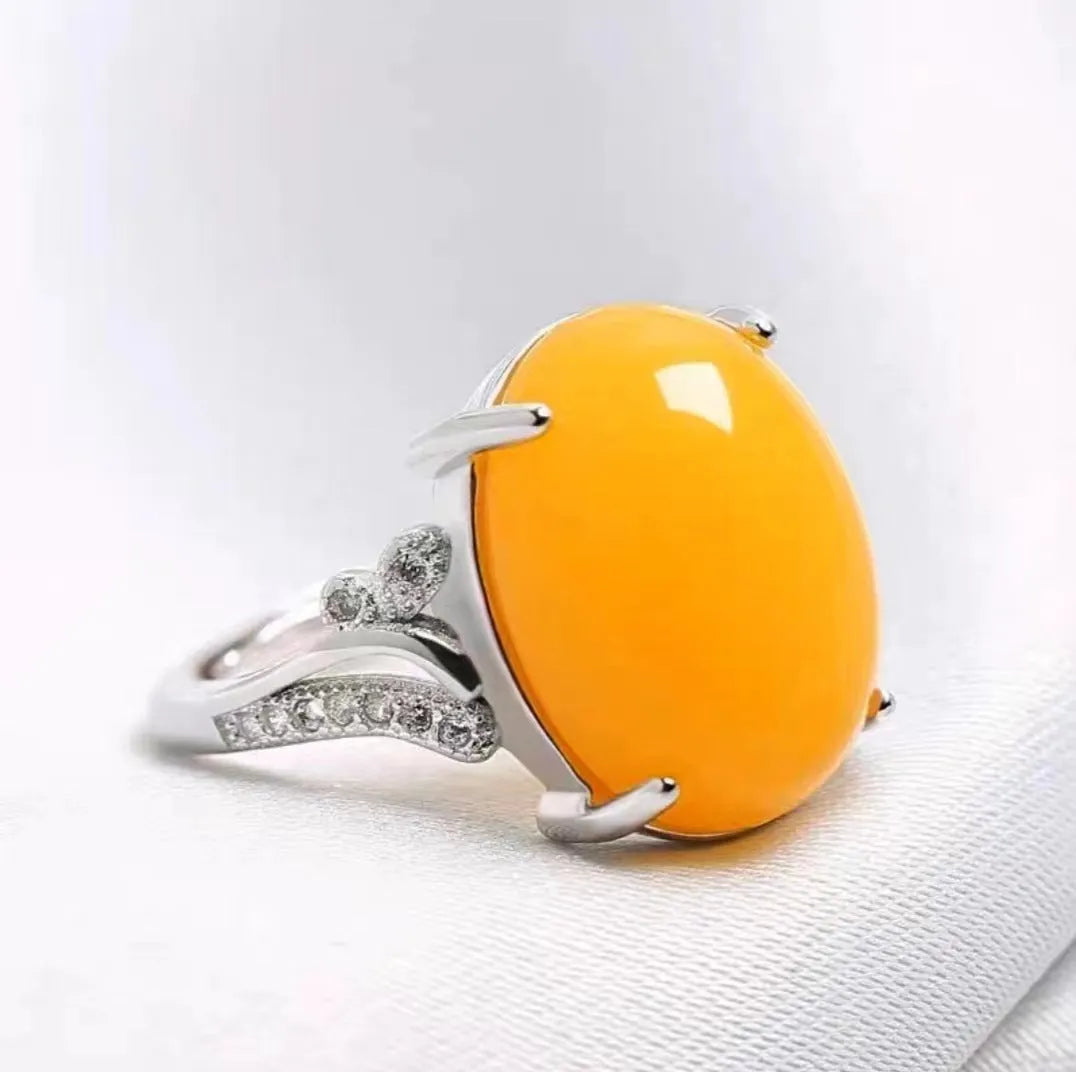Adjustable geometric ethnic-style alloy ring with a natural sapphire, shown in multiple colour options.