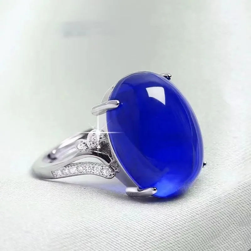 Adjustable geometric ethnic-style alloy ring with a natural sapphire, shown in multiple colour options.